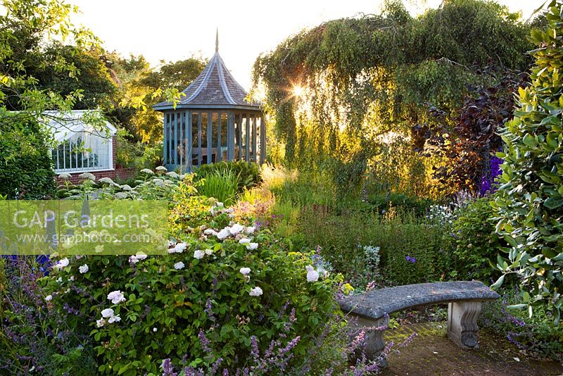 The Corner House, Wiltshire. Summer garden, the elegant summerhouse