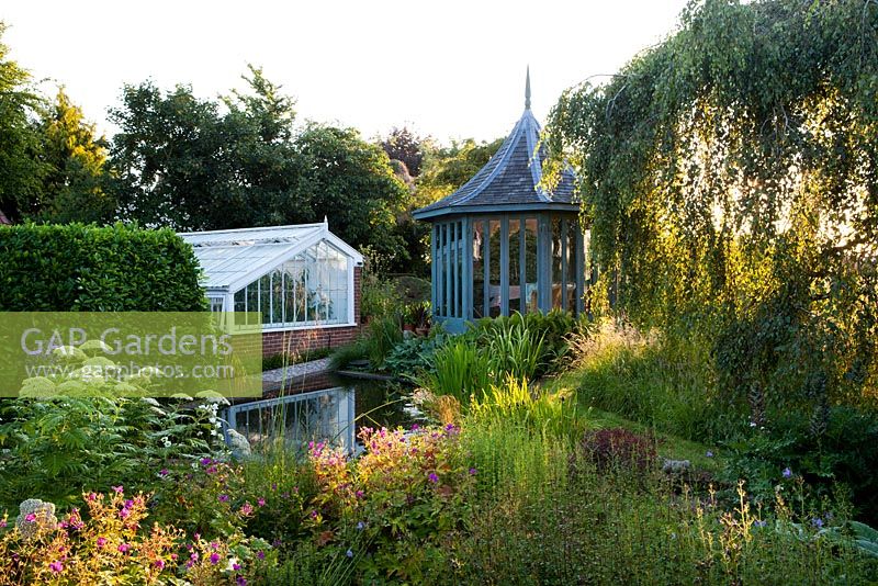 The Corner House, Wiltshire. Summer garden, the elegant summerhouse