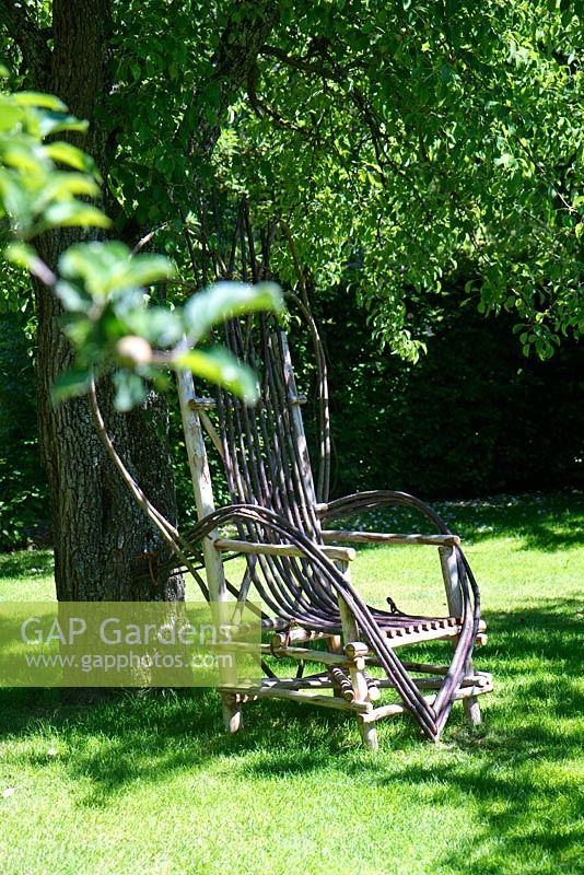 Garden seat made from hazel stems, cut when flexible in spring and fixed to chestnut frame - Le Prieure Notre Dame d'Orsan.