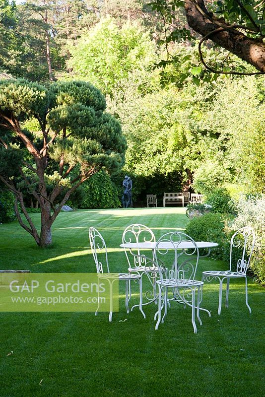 Seating area on lawn in country garden