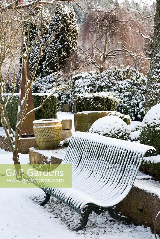 Metal bench with snow