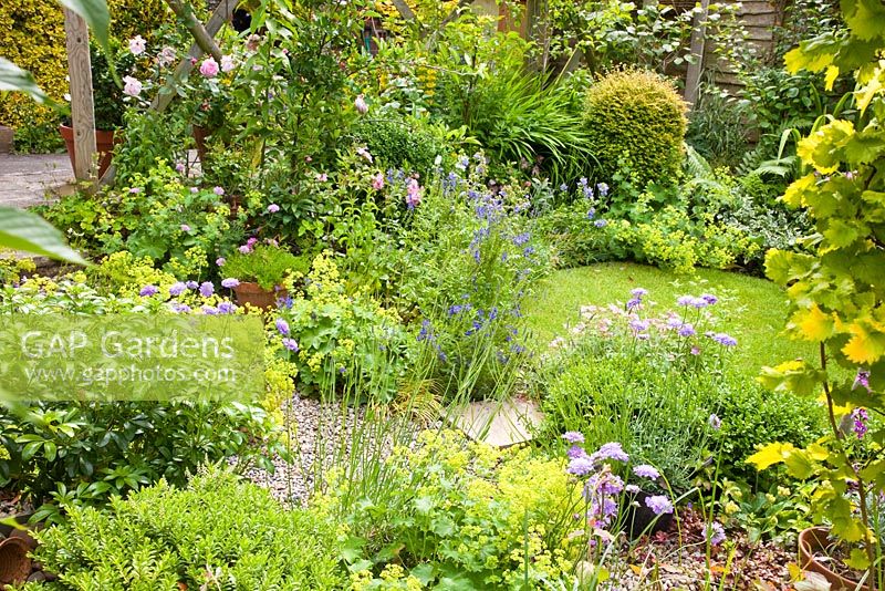 Summer borders and circular lawn at High Meadow Garden in June. Cannock Wood Staffordshire England UK