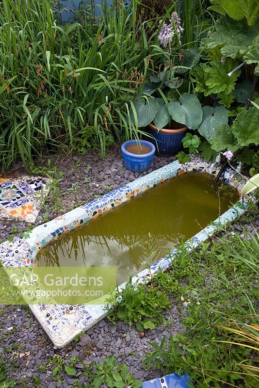 Pond made from recycled bath tub, decorated with mosaic tiles - Growing Together Nursery