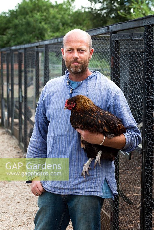 Patrick holding free range chicken - Growing Together Nursery