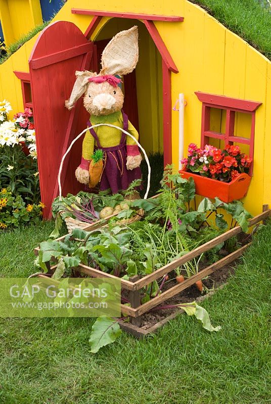 NSPCC  'Happy Rabbit Valley' garden with fun model rabbit by his colourful home and vegetable patch, designed by Andrew Walker. RHS Tatton Flower Show 2011