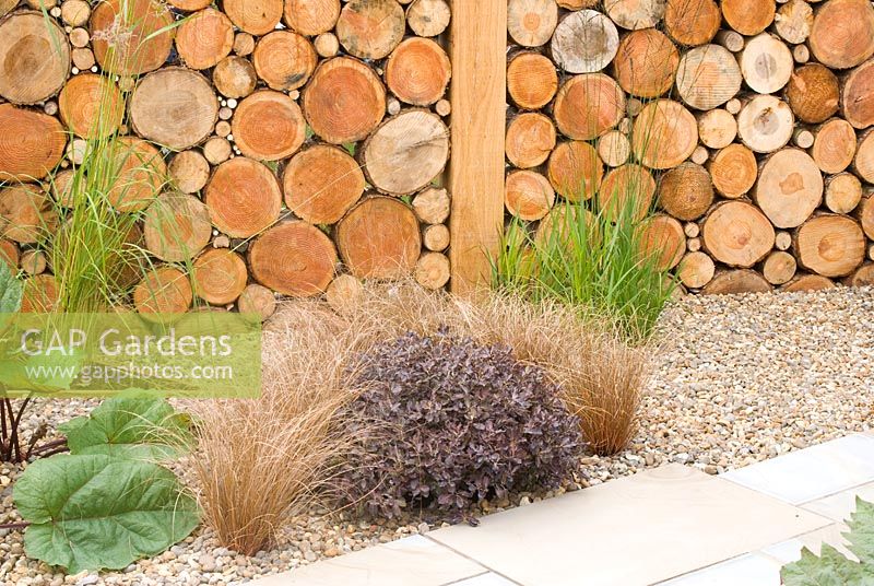 Timber wall created by pattern of logs and gravel bed. Carolyn R Hardern Garden Design 