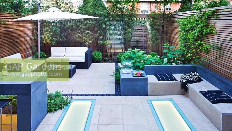 Modern garden with built in benches and dining area 
