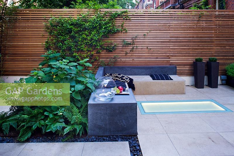 Modern garden with  built in lighting and seating area 
