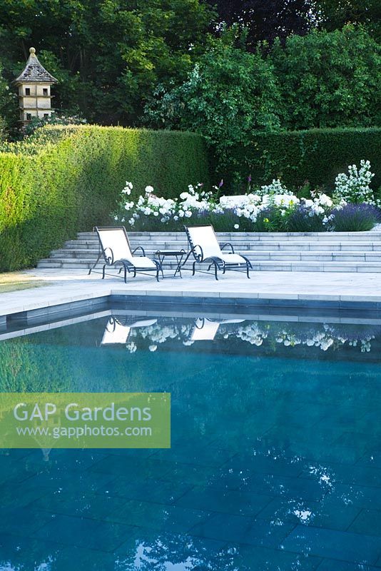 Swimming pool with loungers and white border
