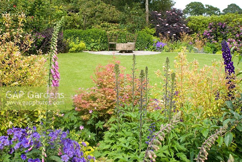 Cottage garden with circular lawn and patio 