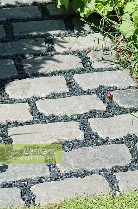 Grey brick path with black chippings 