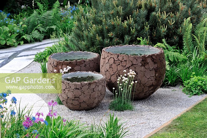 Decorative clay pots containing miniature water gardens 