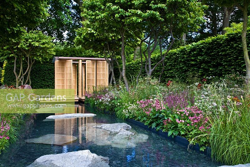 Japanese style pavilion next to pond and Parrotia persica - Persian Ironwood trees, in 'The Laurent-Perrier Garden by Luciano Giubbilei - Nature and Human Intervention' - Gold Medal Winner, RHS Chelsea Flower Show 2011 
