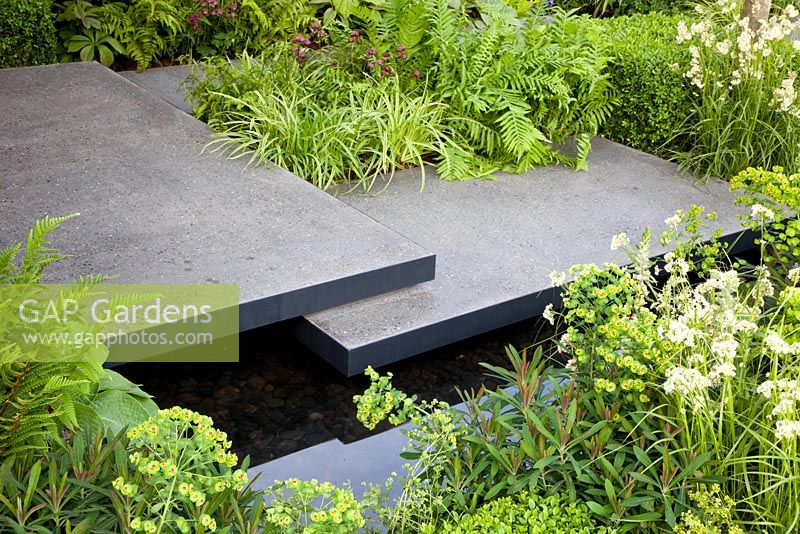 Polished concrete pads form stepping-stones across stream in 'The Lands End Across the Pond Garden' - Gold Medal Winner, RHS Chelsea Flower Show 2011
