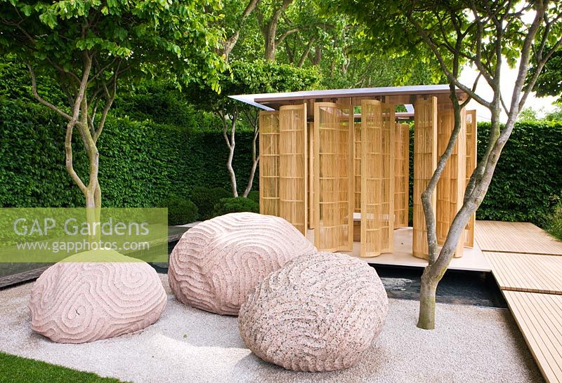 Japanese style carved rocks in gravel beneath Parrotia persica - Persian Ironwood trees - 'The Laurent-Perrier Garden by Luciano Giubbilei - Nature and Human Intervention' - Gold Medal Winner, RHS Chelsea Flower Show 2011 
