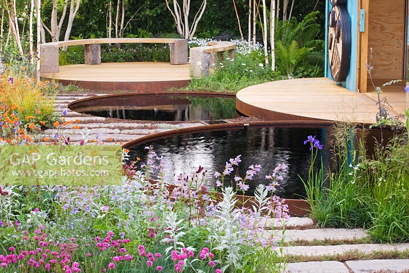 Circular pools to capture rainwater with patio beyond  - 'The Royal Bank of Canada with the RBC New Wild Garden' - Silver Gilt Medal Winner, RHS Chelsea Flower Show 2011 