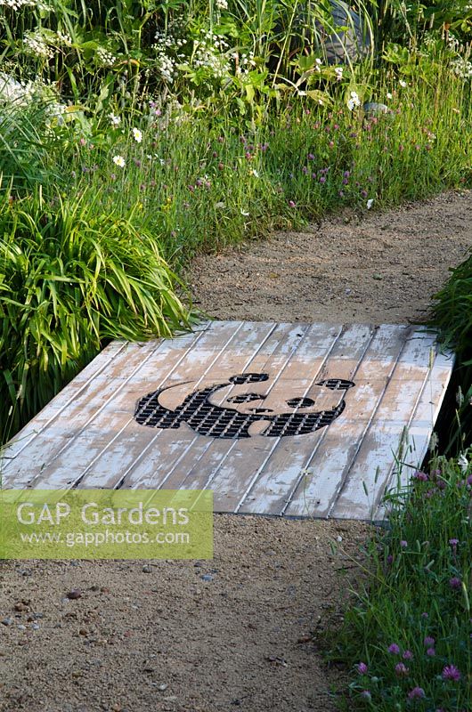 Bridge with WWF logo in the WWF'S 50th Anniversary Garden - 'Why we care about Chalk Streams' Silver Gilt Medal Winner, RHS Hampton Court Flower Show 2011