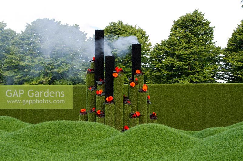 Artificial grass tubes topped with red Begonias. 'Diamonds & Rust' Silver-Gilt medal winner, RHS Hampton Court Flower Show 2011