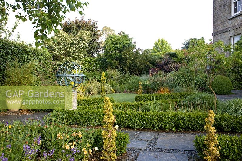 Metal sculpture as focal point in country garden 