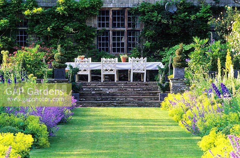 View up Herbaceous borders to dining area at side of house  - High Glanau Manor, Monmouthshire, Wales 