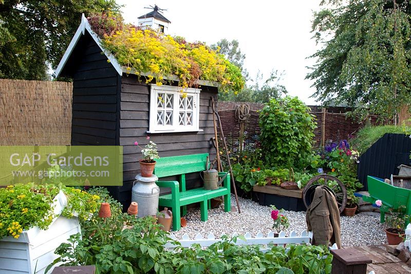 Garden potting shed with living roof and weather vane  - 'The Home Front Garden', Bronze Medal Winner, RHS Hampton Court Flower Show 2011 
 