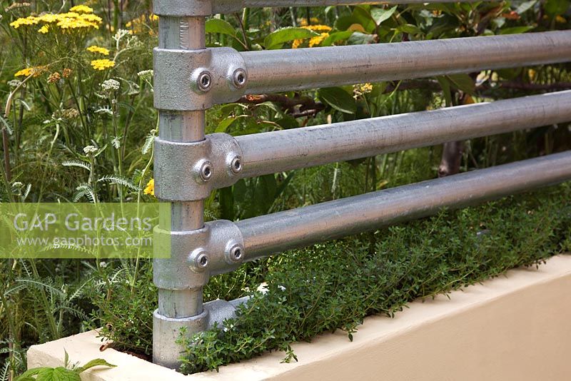 Steel scaffolding poles used to make a boundary screen - The Deptford Project - An Urban Harvest garden - RHS Hampton Court Flower Show 2011