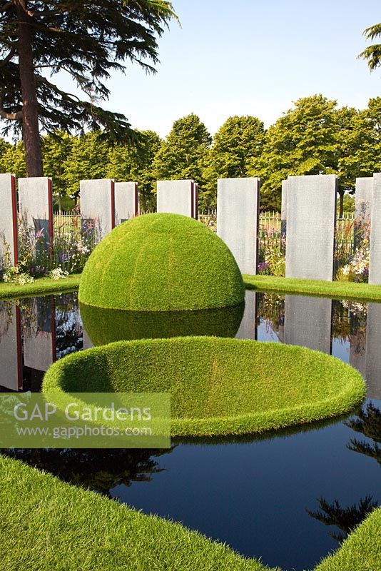 A reflective pool with grass domes in The World Vision Garden - Flemons Warland Design RHS Hampton Court 2011