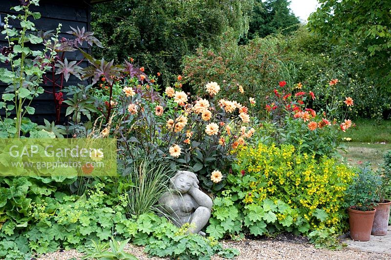 Sculpture in later summer border with Dahlias, grasses and Ricinus - Woodpeckers, Essex NGS