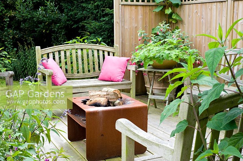 Deck with fire basket, seating and containers - Woodpeckers, Essex NGS
