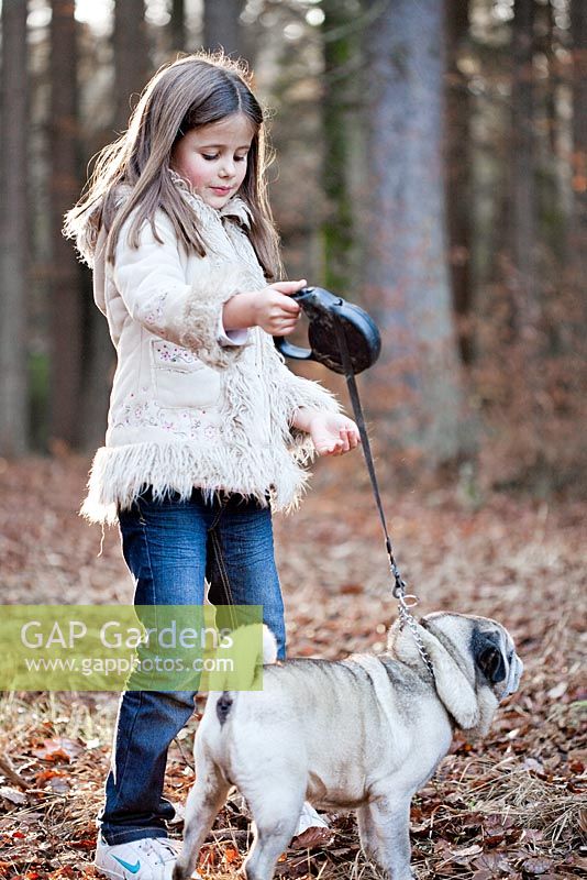 Girl with a dog on a walk in the woods