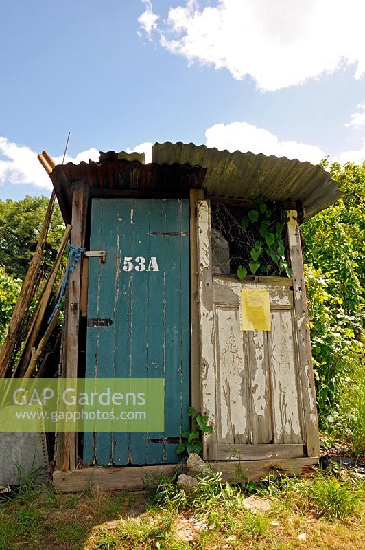 Allotment shed made of old wooden doors with a corrugated iron roof