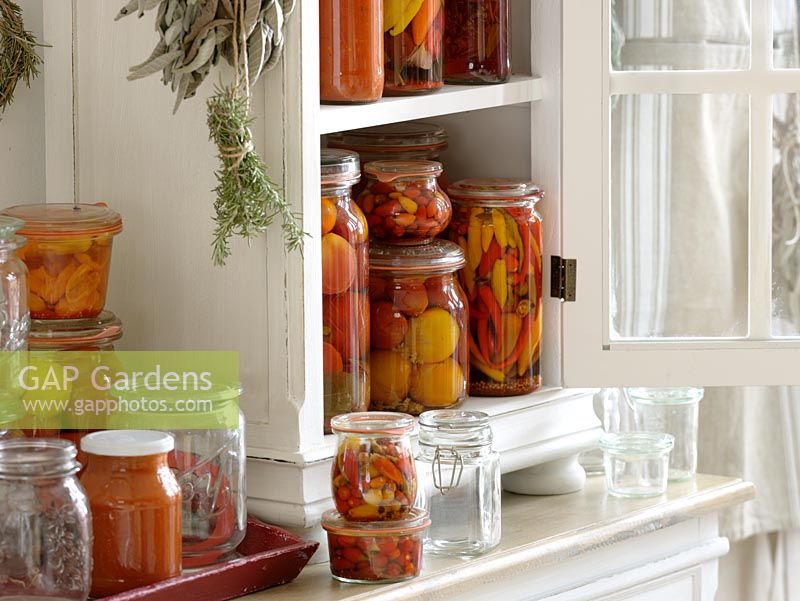 Preserved vegetables and fruits in white cabinet