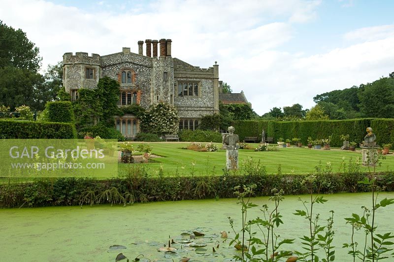 Formal lawns and pond in front of house - Mannington Hall, Norfolk, UK