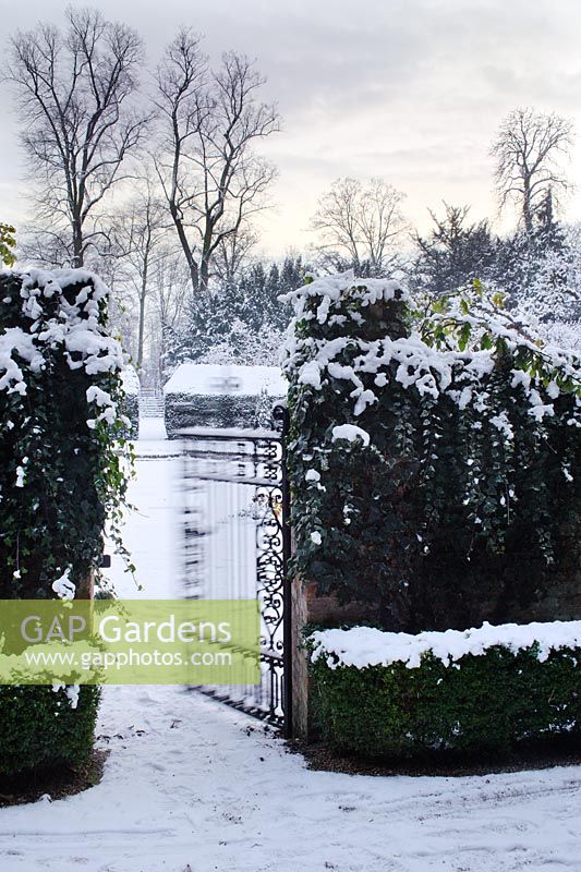 Wrought iron gate with snow in The Fellows' Garden, Clare College, Cambridge