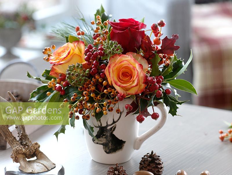 Floral display with Rosa, rosehips, Hedera and Ilex 