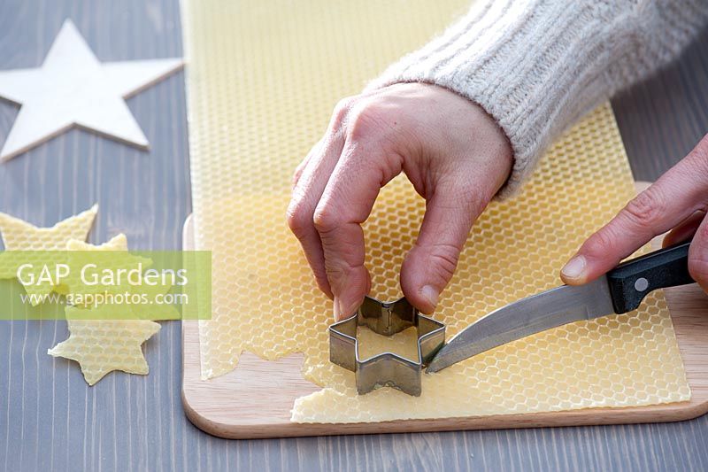 Making decorations - Star cut out of beeswax. Wood and star cookie cutter, knife and wooden board