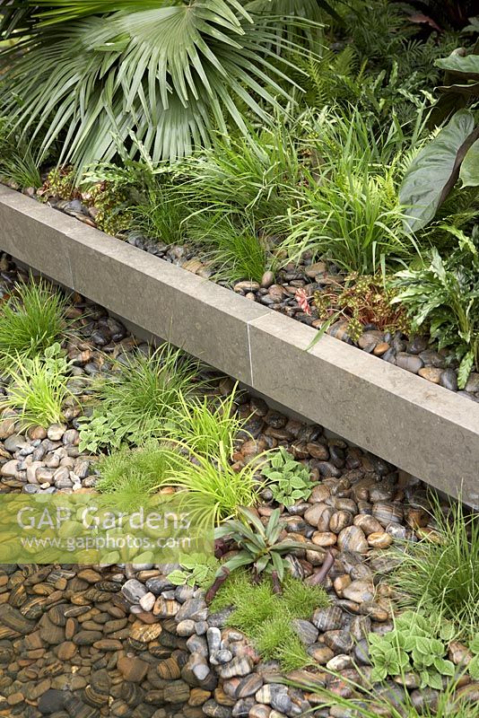 Waterside planting with pebbles - 'Tourism Malaysia Garden', Gold Medal Winner, RHS Chelsea Flower Show 2011