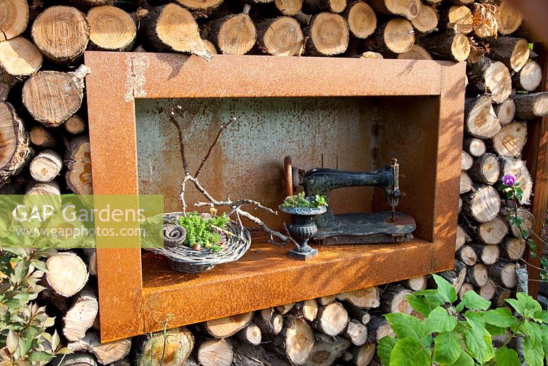 Shelving made from steel in wall containing firewood - Marx garden