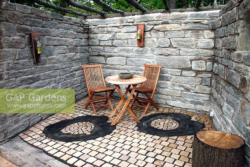 Recessed patio surrounded by natural stone walls