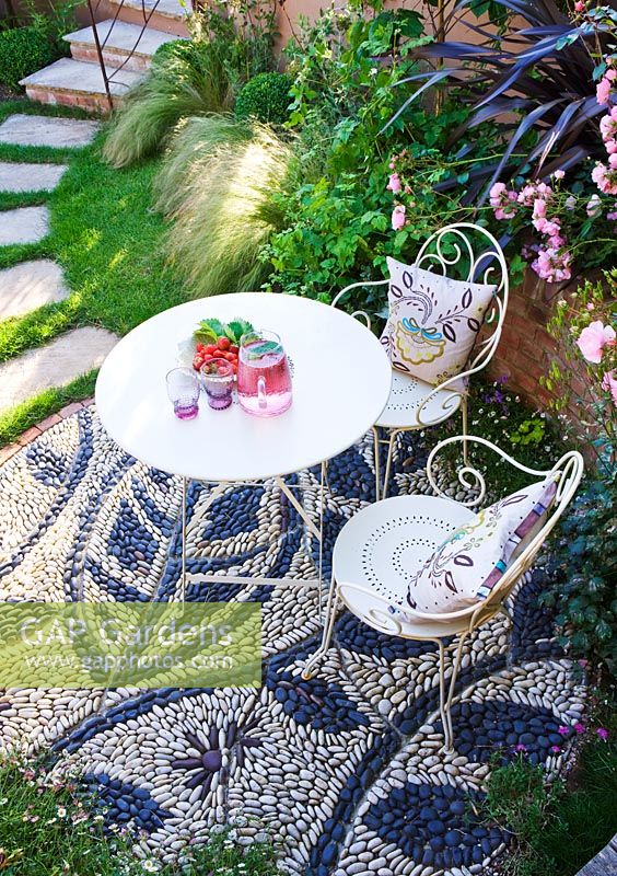 Elevated view of patio with pebble mosaic, table and chairs