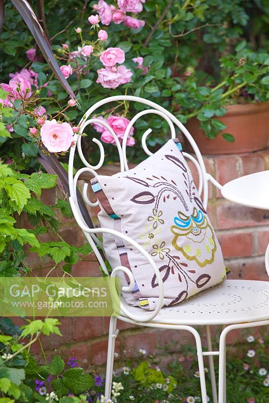 White metal chair and floral patterned cushion