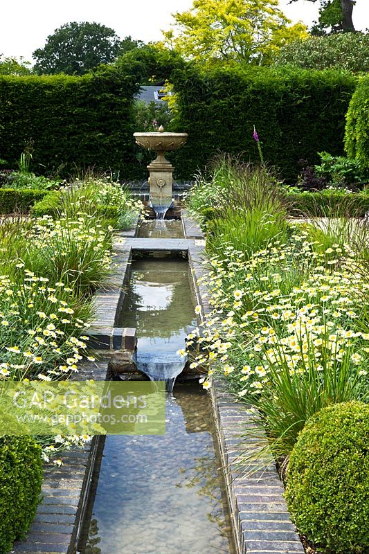 Water feature in the formal garden at Merriments Gardens, Handcross, East Sussex 
