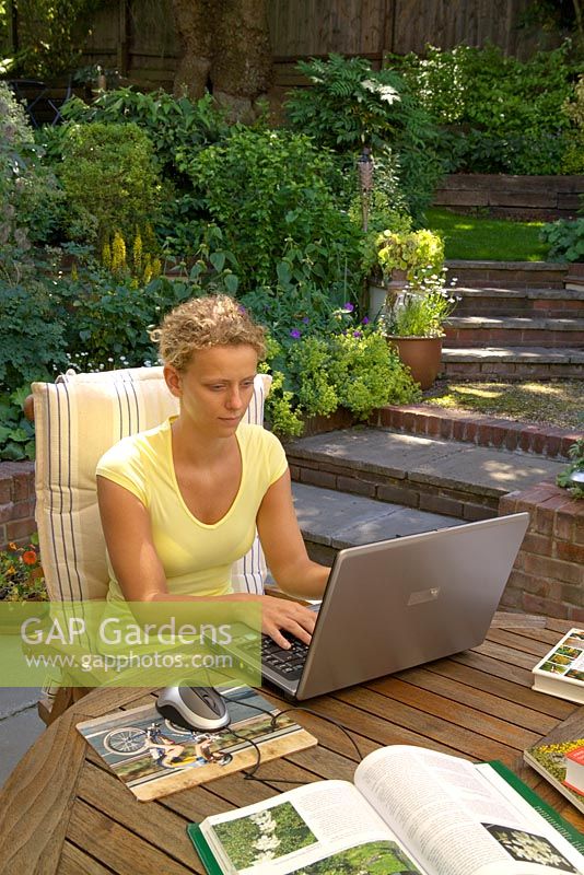 Woman using laptop in garden