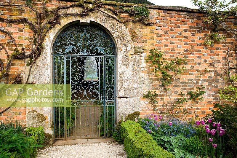 Blue wrought iron gate into the Walled Garden - Rousham House, Bicester, Oxon, UK