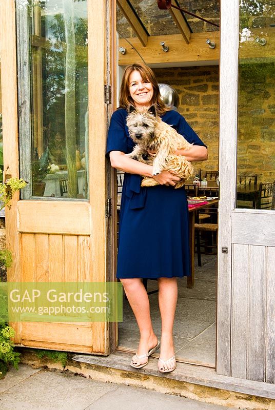 Louise Dowding, garden designer, with the family dog Toto - Yews Farm, Martock, Somerset, UK