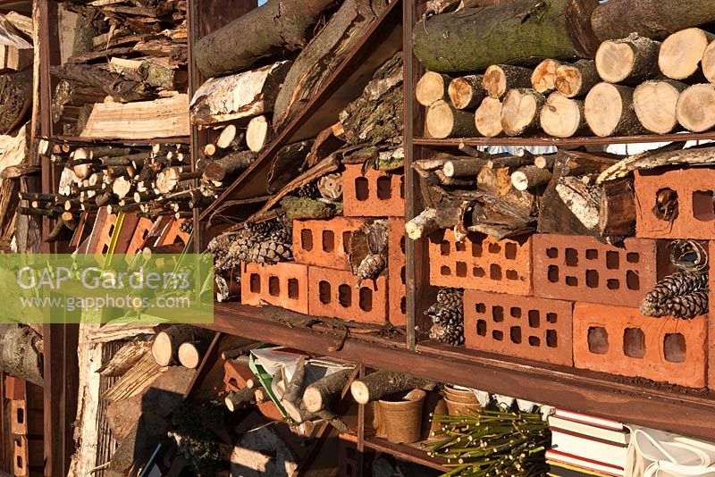 Insect hotel made from bricks, logs and pine cones