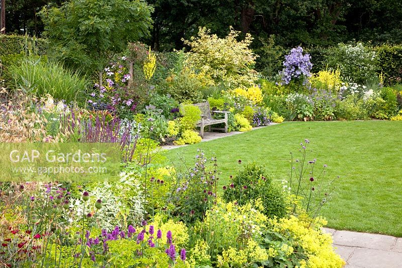 Colourful Summer borders edging lawn