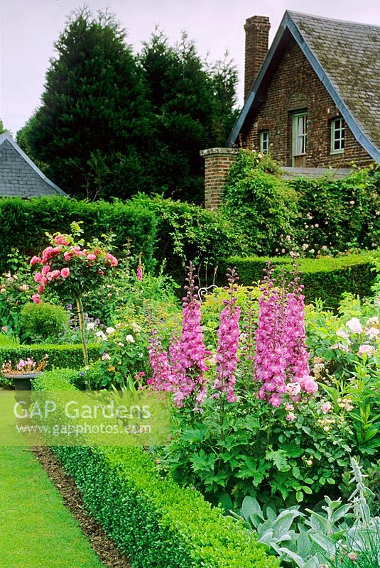 Parterre with summer planting in formal country garden 