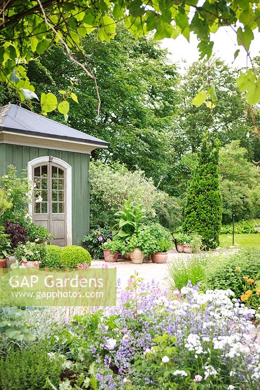Garden house with containers and perennials at Gothenburg Botanical Garden, Sweden