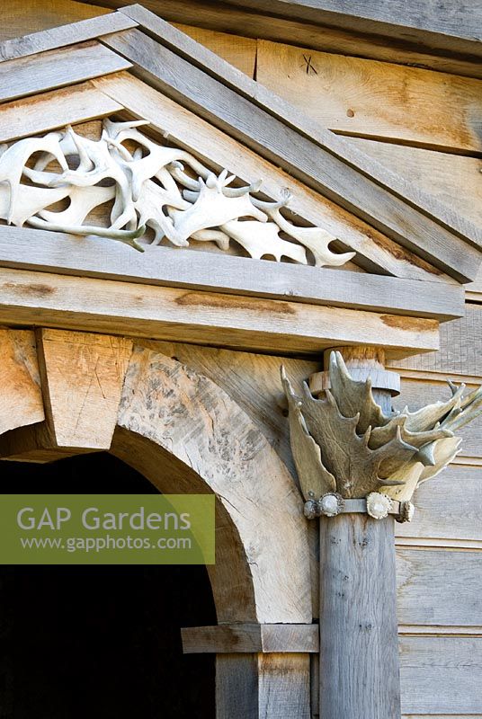 Detail of temple building on the upper terrace of the Collector Earl's Garden designed by Julian and Isabel Bannerman, made from oak and featuring deer antlers found in Sussex parkland.